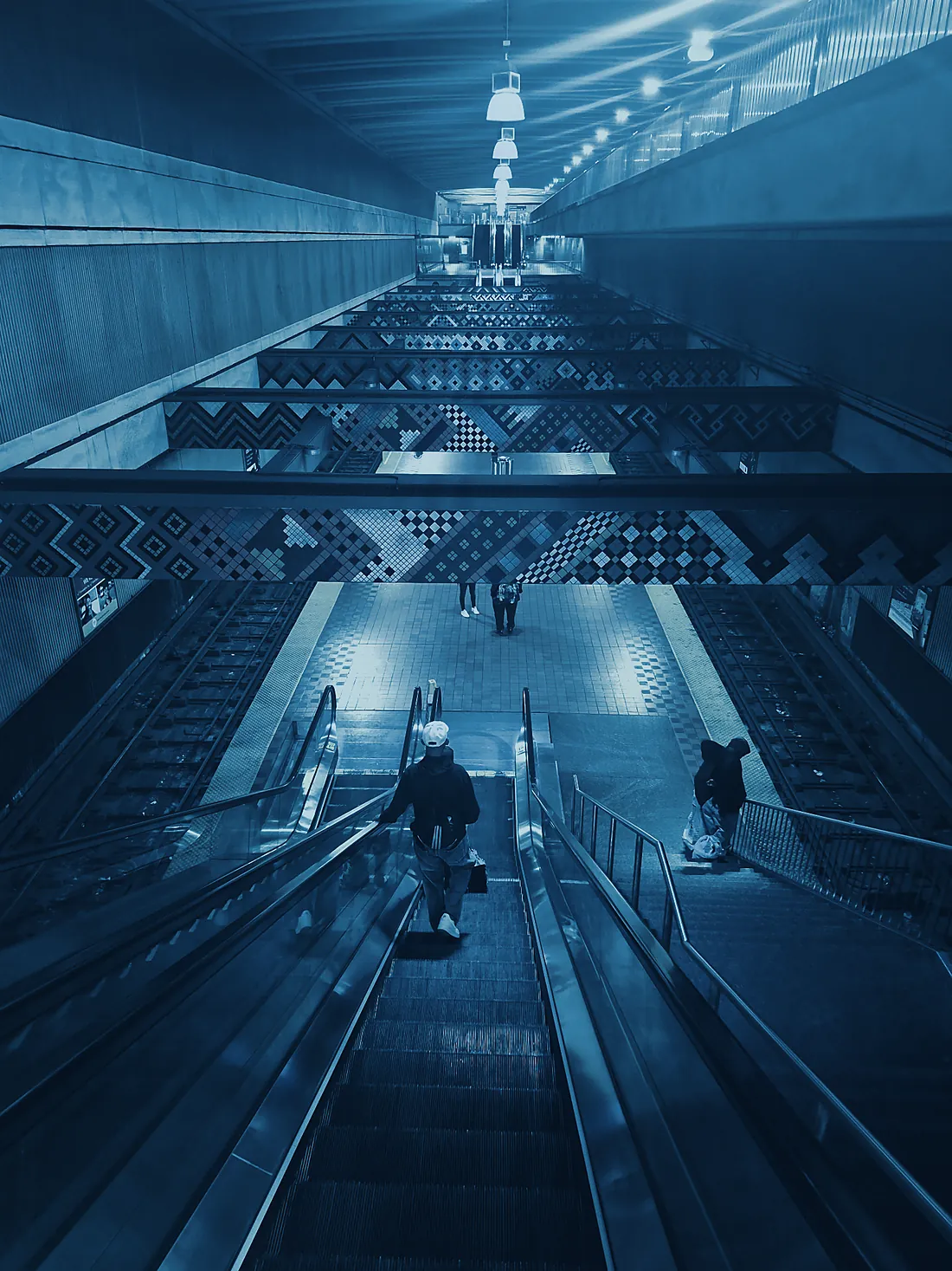 A Baltimore transit station stair hall with mosaic tilework, rendered in deep blue